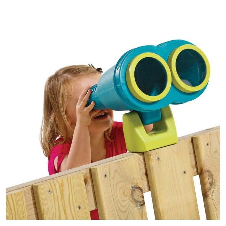 girl looking through the turquoise playground binoculars on a wooden fence