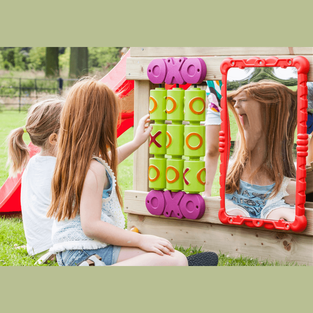 2 girls playing with tic tac toe set and sensory haha mirror