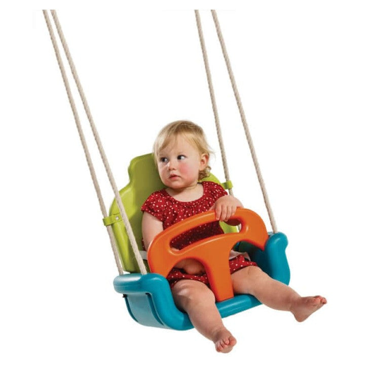 child sitting in a growing baby swing that converts to swing seat when child is older.