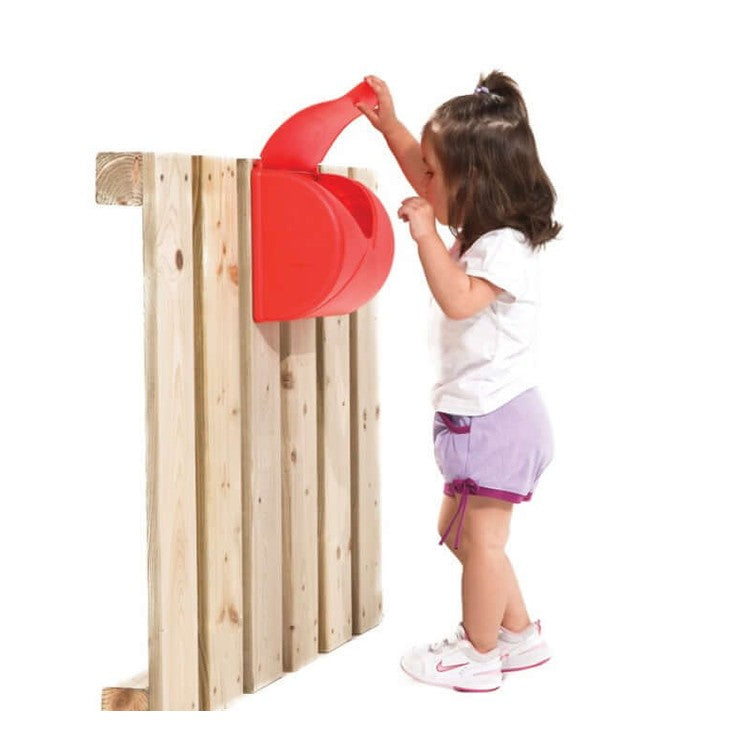 Child opening a red letterbox on a wooden fence