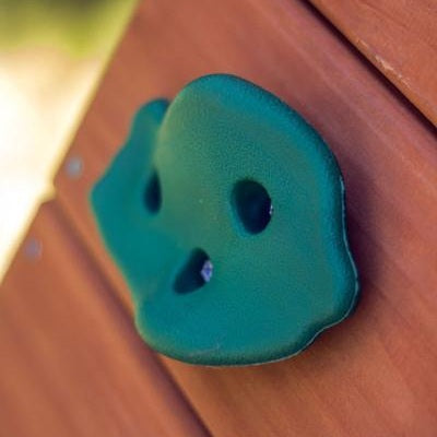 Green climbing hold on a wooden surface