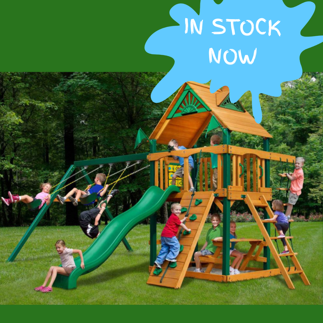 Children playing on a wooden playground set with a green slide in a NZ backyard
