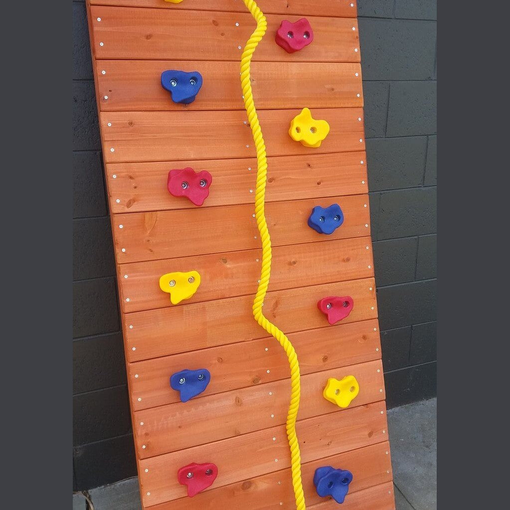 wooden climbing wall with multi-coloured rock holds and climbing rope