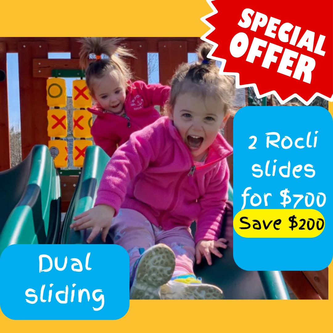 Two children sliding down a playground slide with promotion for 2 slides for $700