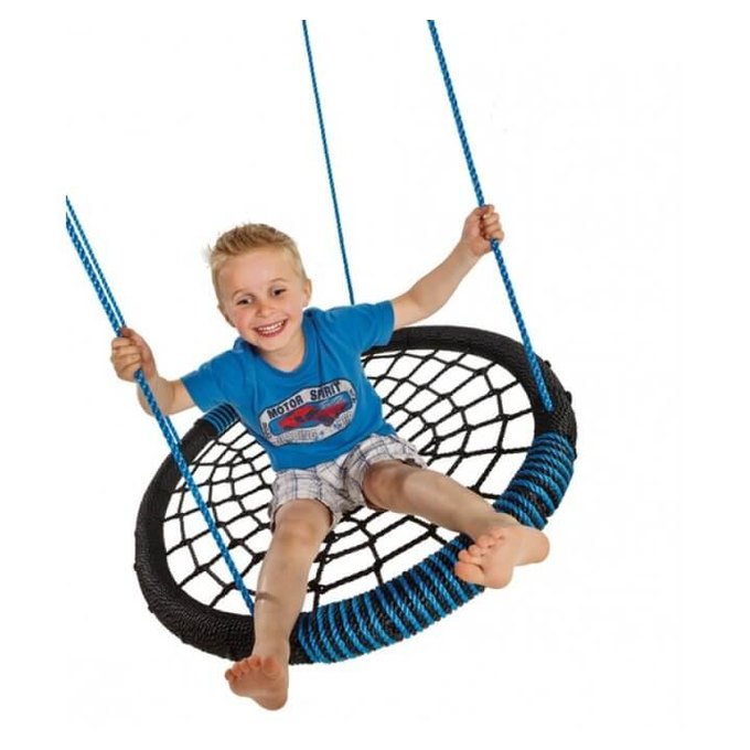a boy swinging on a round blue and black nest swing