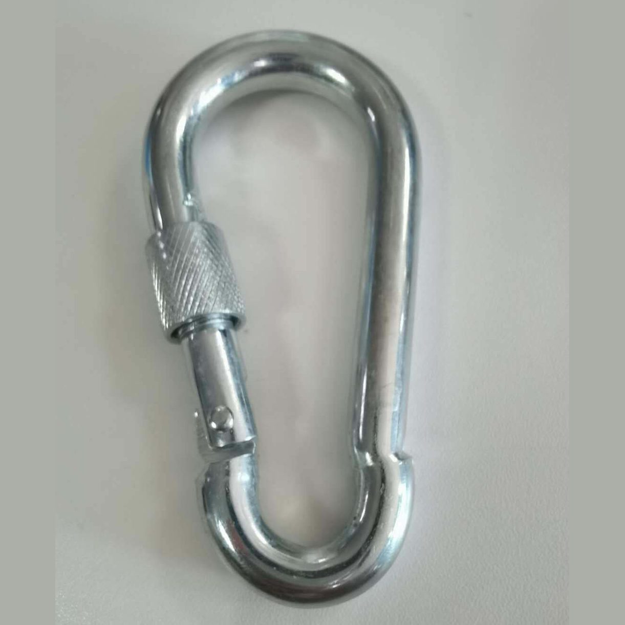 Metal carabiner on a white background