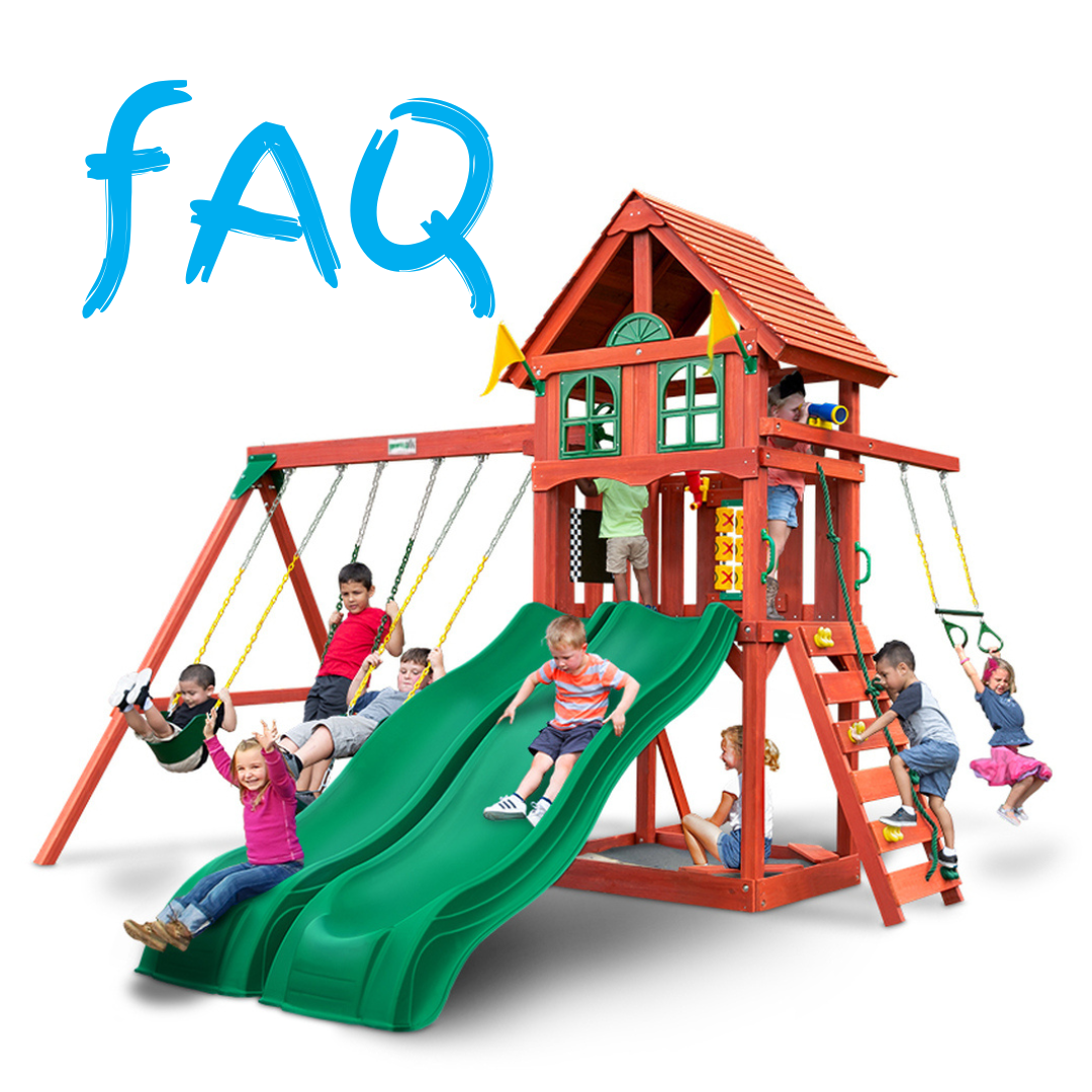 Children playing on a wooden playset with 2 green slides and multiple swings.