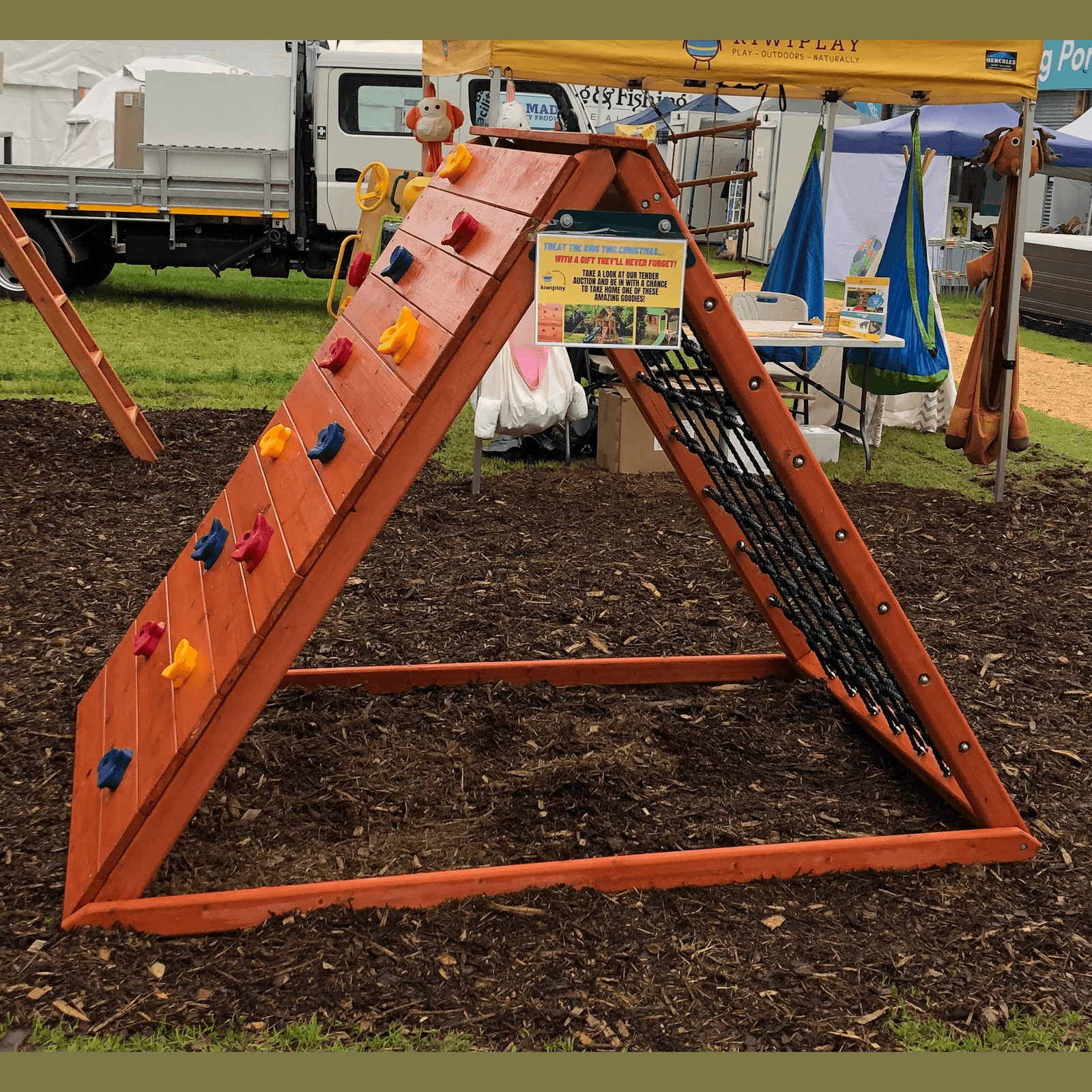 climbing frame with a rock wall and a scramble net