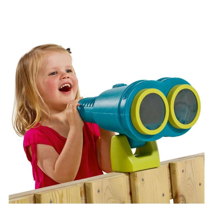 girl playing with turquoise star binoculars on a wooden fence