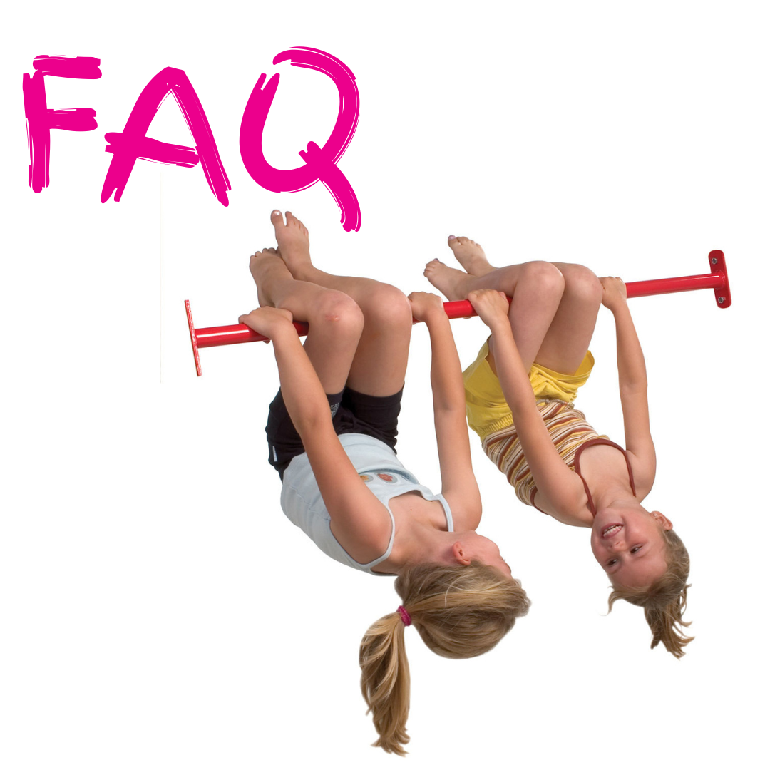 Two children hanging from a red tumble bar smiling