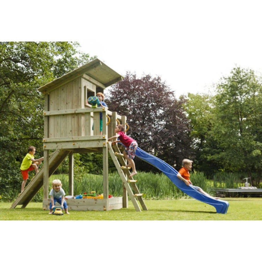 Children playing on a wooden playhouse with a slide in a garden setting.