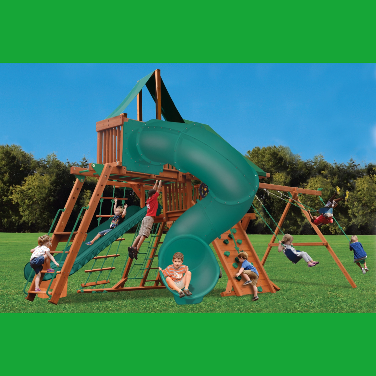 Children playing on a wooden playground set with a green slide and swings.
