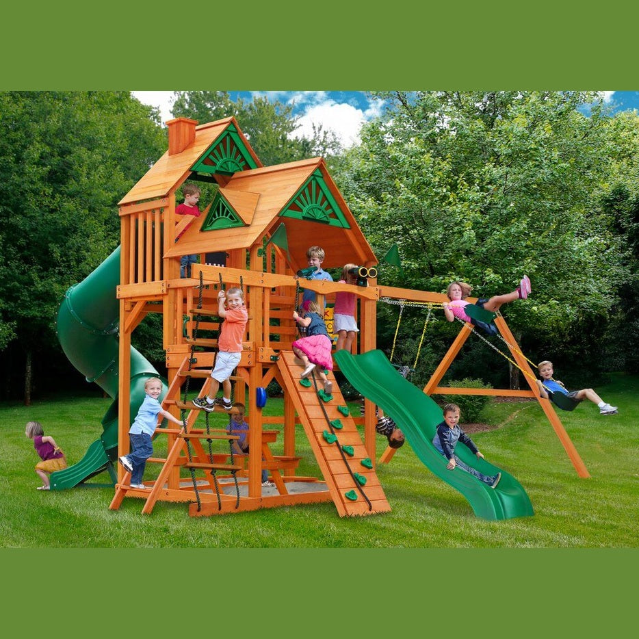 Children playing on a wooden playground set with slides and swings in nz backyard
