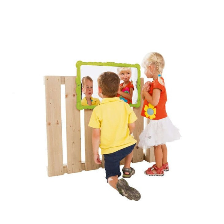 two children playing with a sensory mirror that distorts the appearance of their face in funny patterns