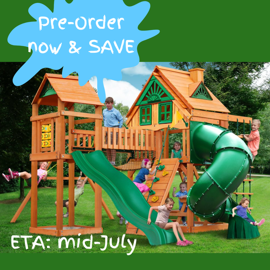 Children playing on a wooden playground set with a green wave slide and green tube slide