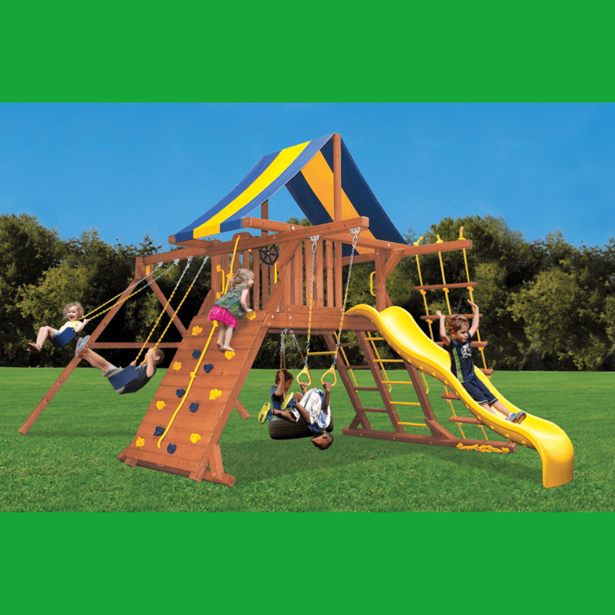 A large wooden backyard playground set with a climbing ladder, rope swings, hanging rings, a yellow slide, and a blue-and-yellow canopy, shown outdoors on grass with children playing. The image has green bars at the top and bottom.