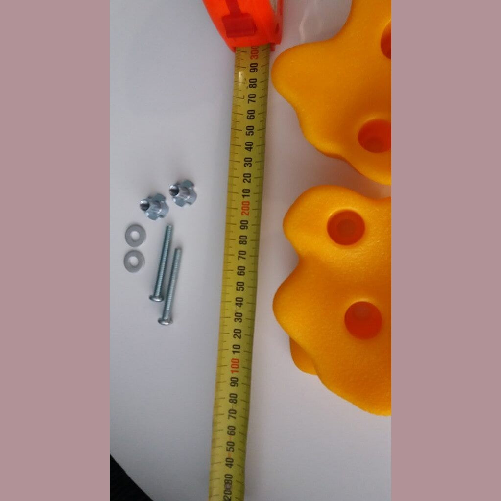 tape measure next to yellow rock holds