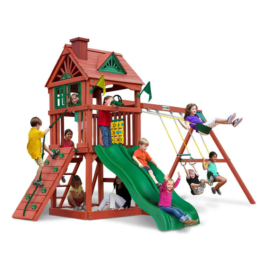 Children playing on a red playset with green slide and swings on a white background