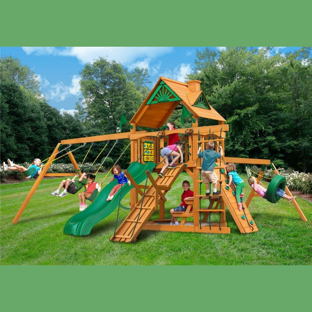 Children playing on a wooden playground set with slides and swings in a nz backyard