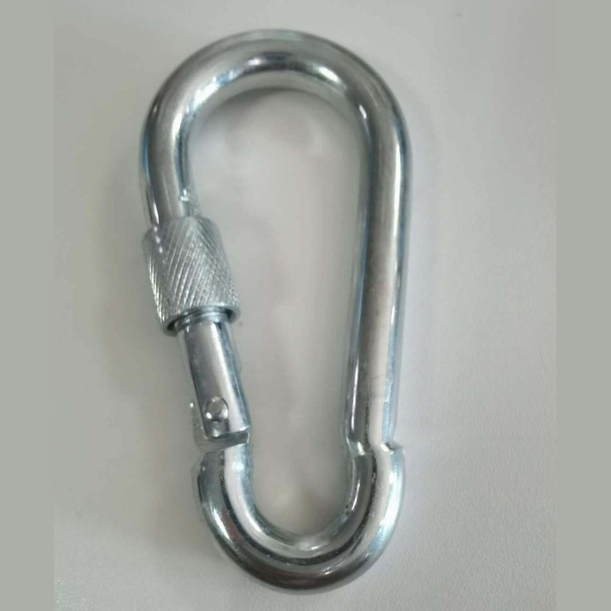 Metal carabiner on a white background