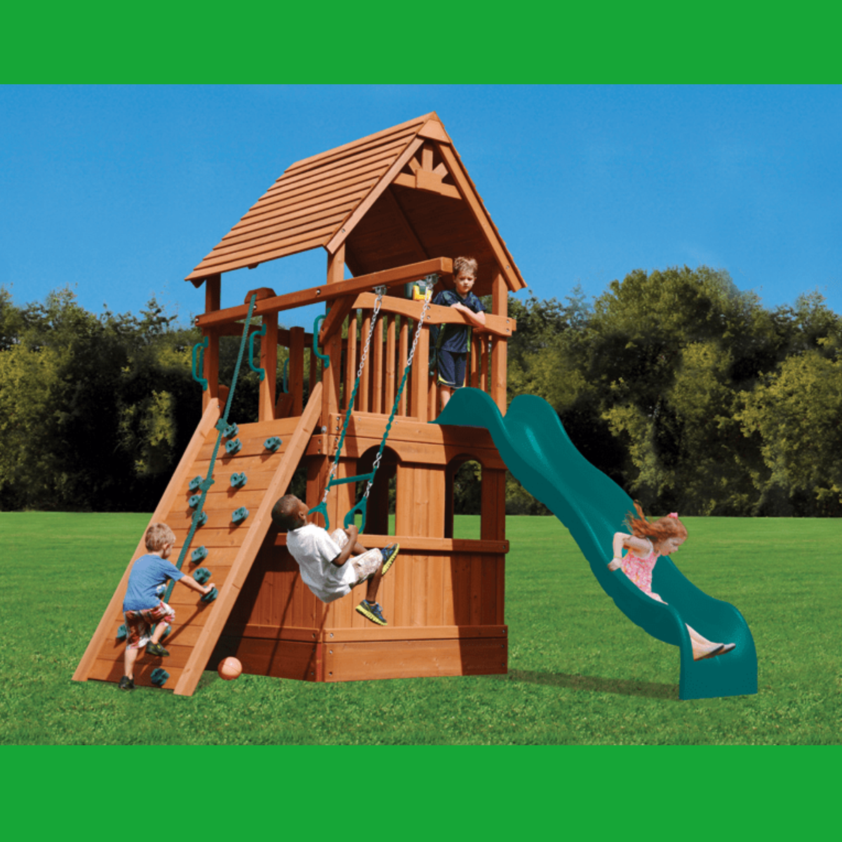 A wooden children's playset with a green slide, climbing ladder, rope swing, and elevated platform, shown outdoors on grass with children playing under a blue sky.