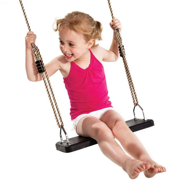 Girl smiling while on rubber swing seat swinging