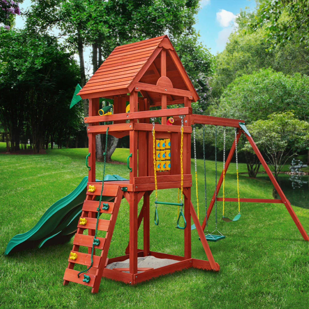 Children playing on a wooden swing set with green slide in a nz backyard